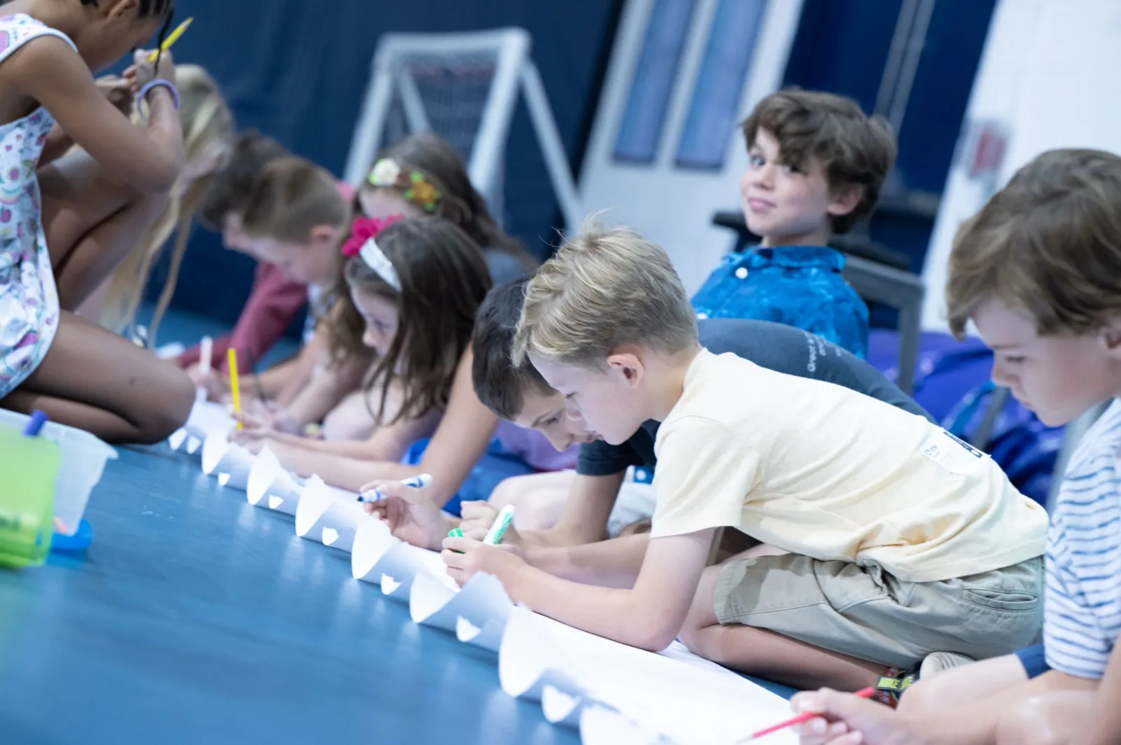 Children working on a project together at a long table